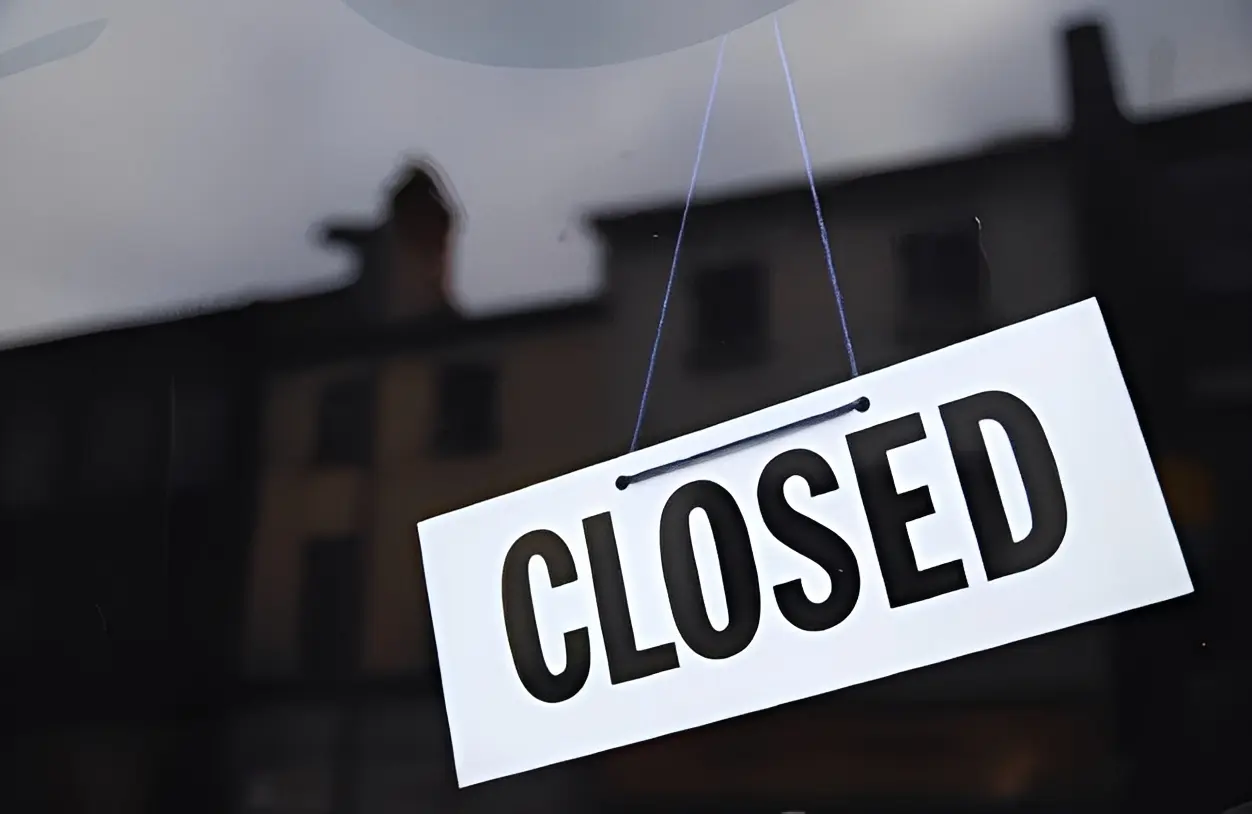 Closed sign hanging in a shop window.