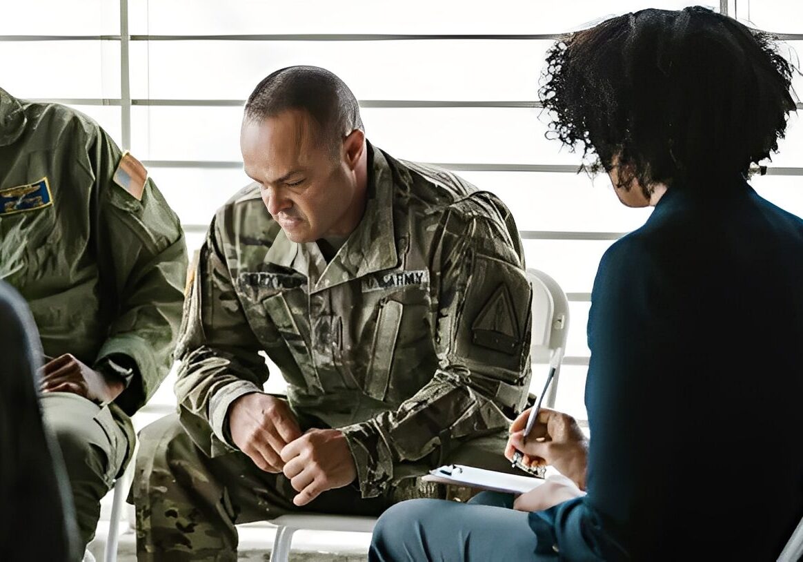 Military personnel in a group therapy session.